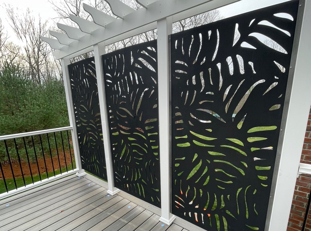 A Deck With A Black Screen And Wooden Railing